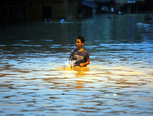 Residents of Marikina city flee from swelling river.
