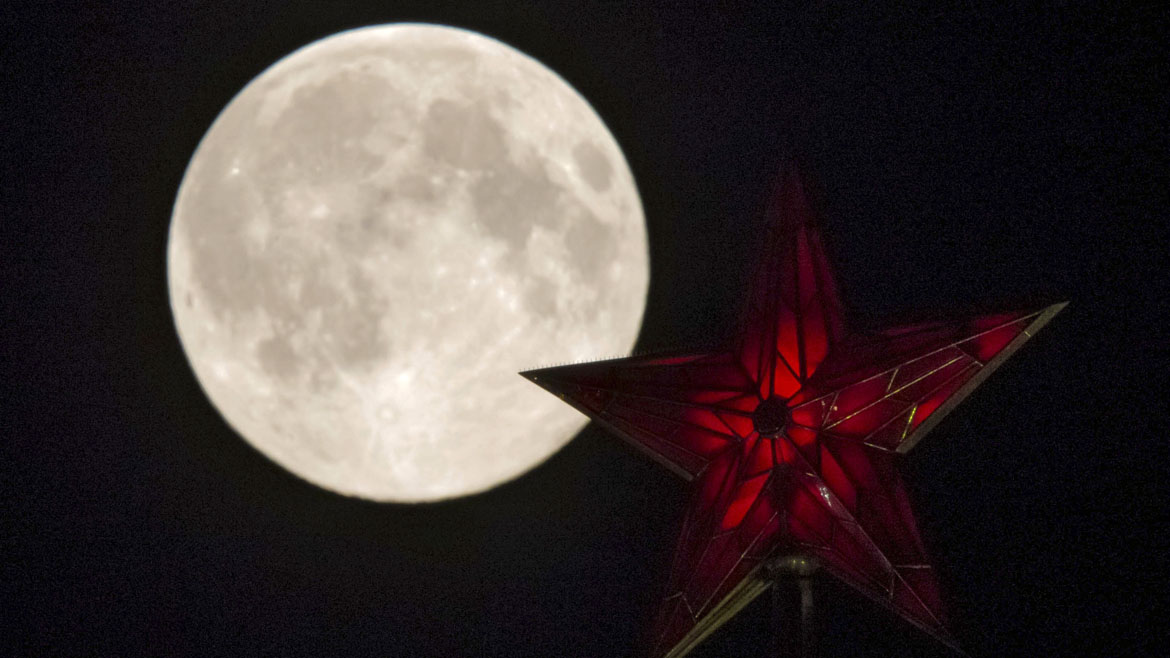 The supermoon rises over the stars of Moscow's Kremlin towers in Moscow