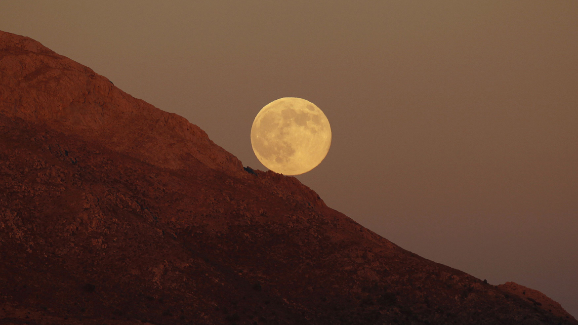 Supermoon rises as it is pictured from Sierra de las Nieves nature park and biosphere reserve between El Burgo and Ronda