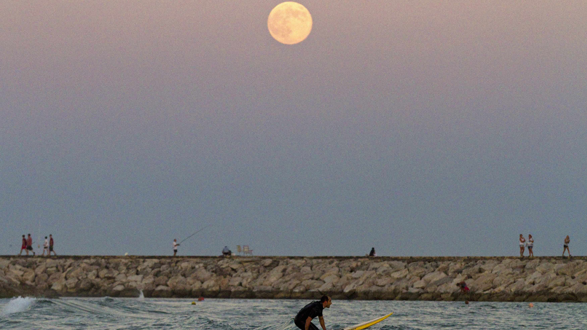 The supermoon rises over the Mediterranean sea at Cabopino beach in southern Spain