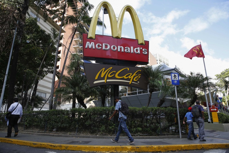 People walk past a McDonald's restaurant in Caracas