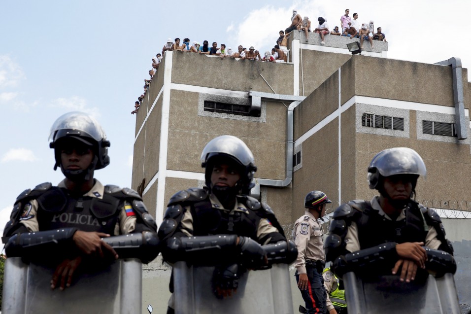 Inmates gather on the roof of the prison of the National Bolivarian Police during a riot in Caracas