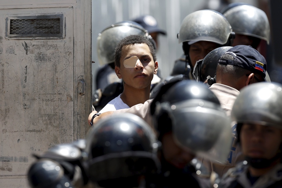 An inmate who took part in a prison riot at the National Bolivarian Police prison is transferred to another prison, in Caracas