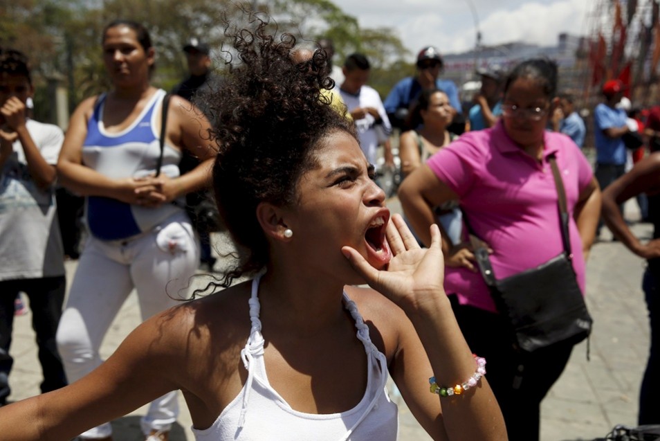 A relative of an inmate shouts outside the prison of the National Bolivarian Police during a prison riot in Caracas